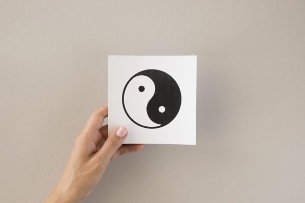 front-view-person-holding-ying-yang-symbol